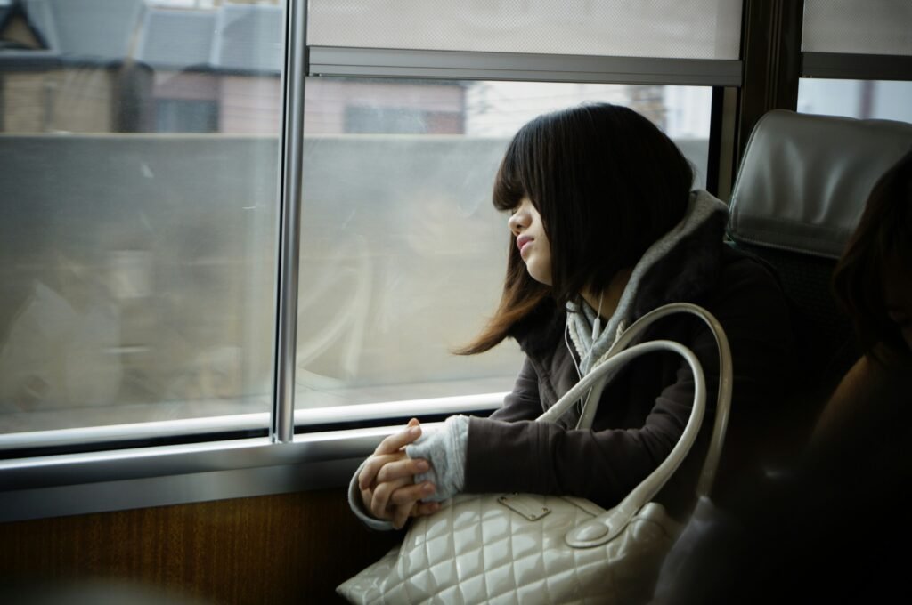 exhausted girl looking out a window