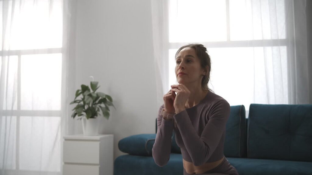 A thoughtful woman on her knees in natural light. 