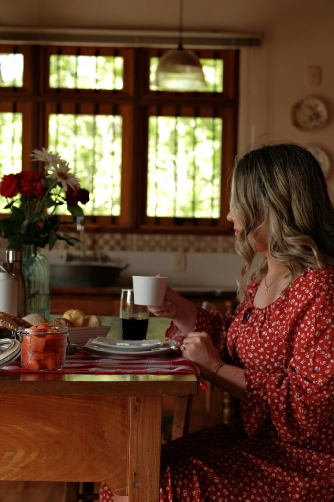 Woman sitting quietly at a kitchen table