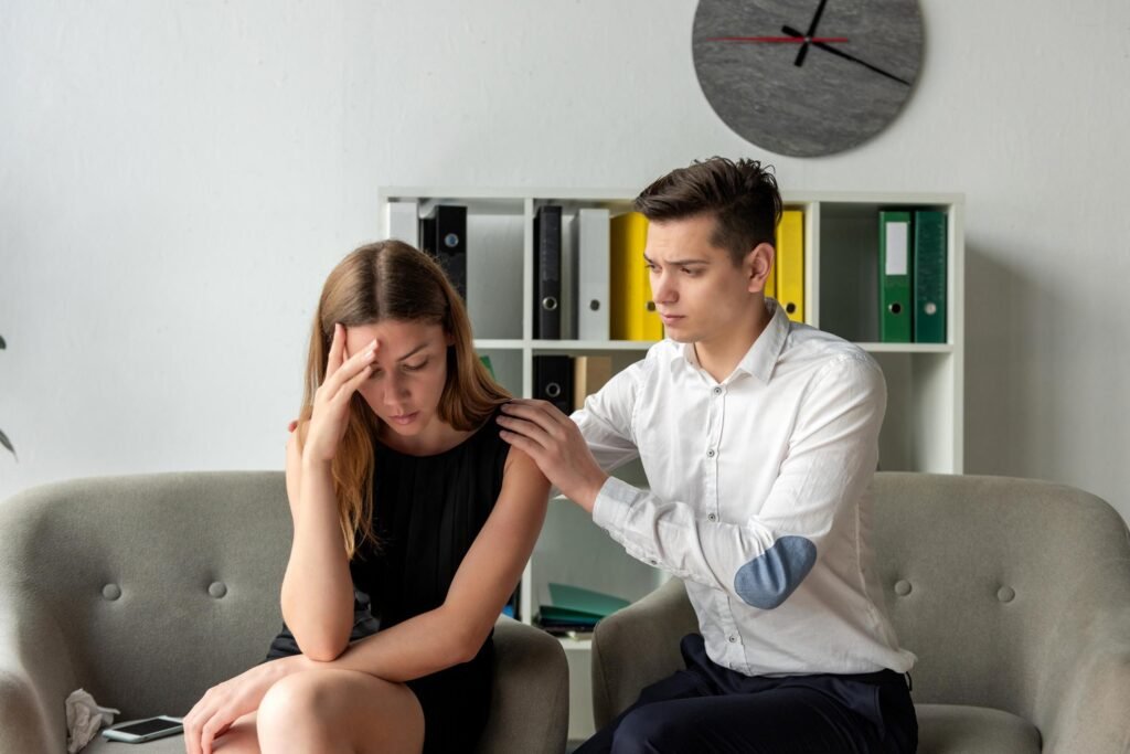 Woman supporting a distressed partner struggling with addiction while quietly carrying the consequences.